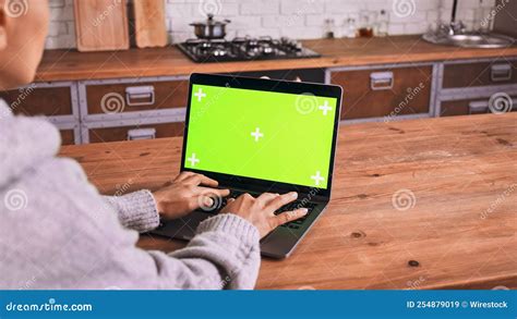 Female Working On A Laptop With A Green Screen In The Office Stock