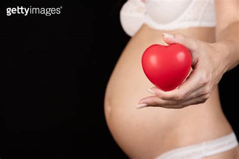 Naked Pregnant Woman Holding A Red Heart In Her Hands IVF Medicine