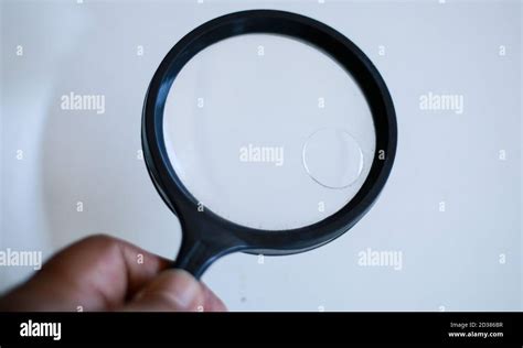 Use a magnifying glass to see small objects Stock Photo - Alamy