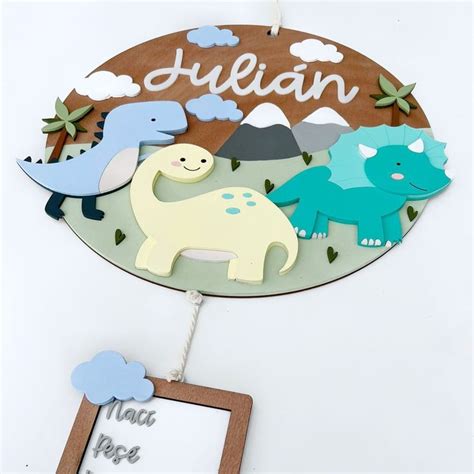 A Wooden Sign With Dinosaurs On It And A Name Tag Hanging From The