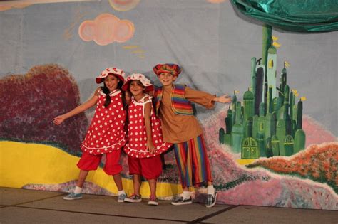 Munchkins And Mayor In Front Of The Emerald City Costumes And Sets By