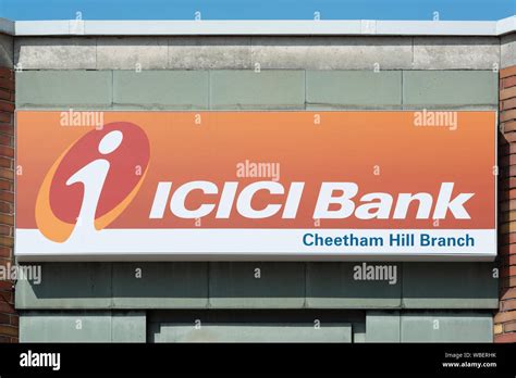 Signage indicating a branch of ICICI Bank located at the junction ...