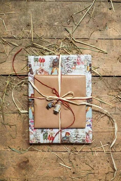 A Wrapped Gift Sitting On Top Of A Wooden Floor Next To Dry Grass And Twigs