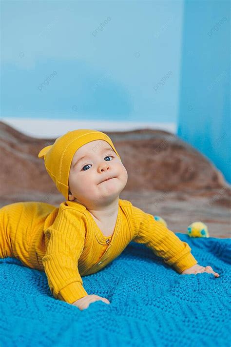 Baby In Yellow Clothes Starts Holding Head On Bed Photo Background And Picture For Free Download ...