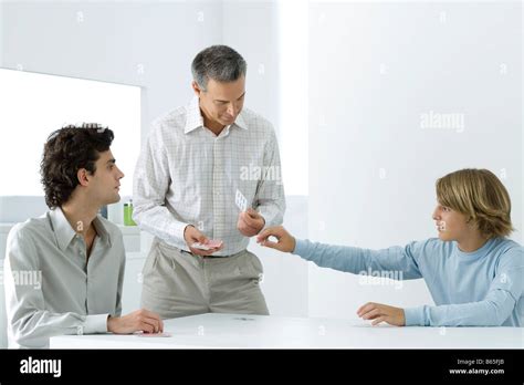 Mature Father And Two Sons Playing Cards Stock Photo Alamy
