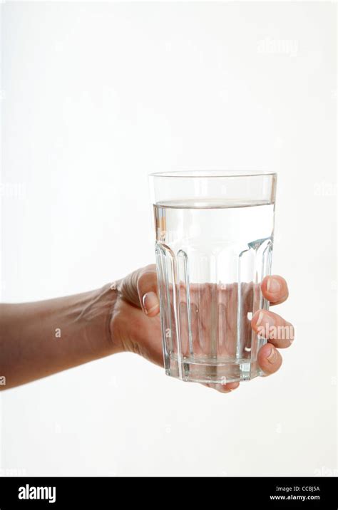 Woman S Hand Holding Glass Of Water Stock Photo Alamy