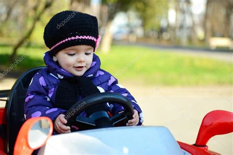 Little girl driving car Stock Photo by ©khorzhevska 127987534