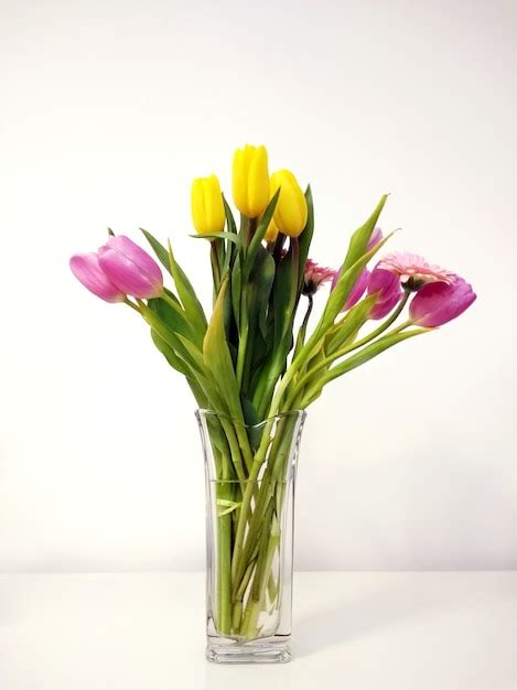 Free Photo | Vertical shot of a tulip bouquet in a vase on the table ...