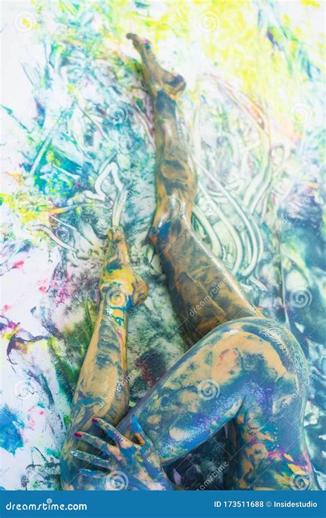 Top View Of A Naked Woman In A Spray Of Paint A Girl Without Clothes Lies On A White Floor In