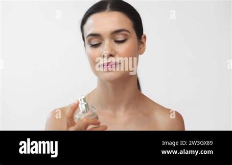 Beautiful Naked Woman Spraying Perfume And Smiling Isolated On Grey Stock Video Footage Alamy