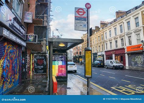 Bus Stop At Brick Lane With Vintage Building Backdrop In London