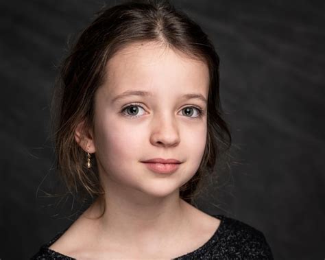 Premium Photo Portrait Of Smiling Girl Against Black Background