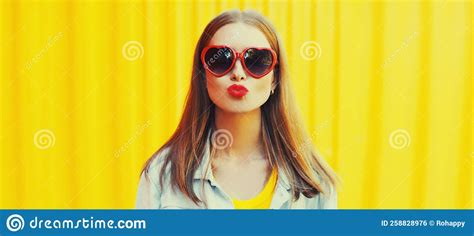 Summer Portrait Of Beautiful Young Woman Blowing Her Red Lips Sending