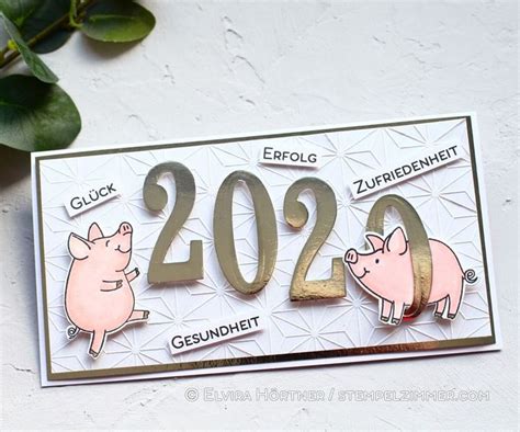 A Card With Two Pigs On It And The Year 2090 Written In Gold Foil