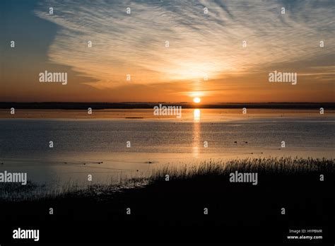 Beautiful Sunrise Over Country Lake With Orange Clouds And Reflections