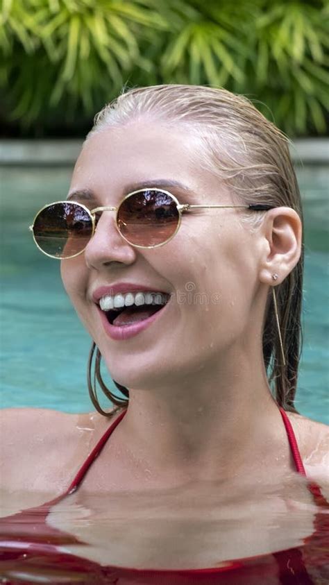 Vertical Portrait Of Confident Smiling Happy Woman In Pool Looking Into Camera Woman Wearing