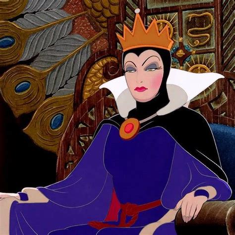 The Evil Queen Is Sitting Down Wearing A Crown