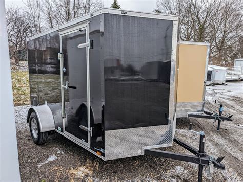 New 2024 CARGO MATE 6x10 V Nose With Ramp Door Cargo Enclosed Trailer