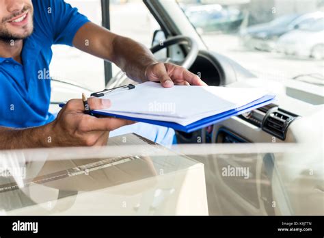 Delivery Man With Clipboard Stock Photo Alamy