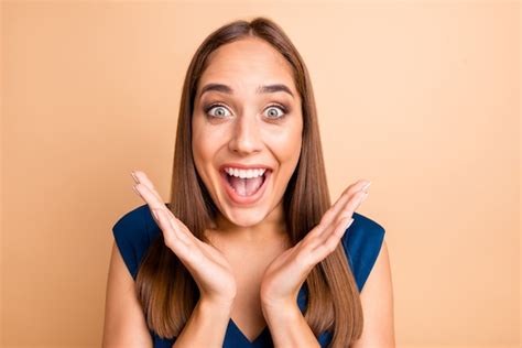 Premium Photo Brunette Woman In Blue Dress Posing Against The Peachy Wall