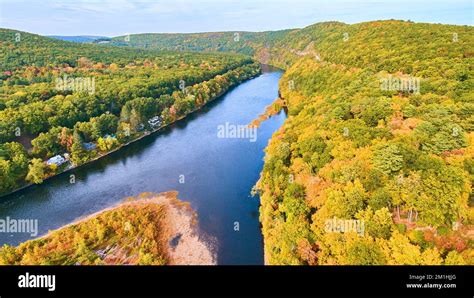 Aerial over stunning Delaware River with fall foliage forests around ...