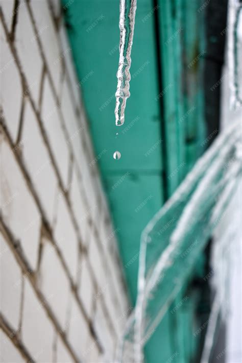 Premium Photo Icicles Hang From The Roof Of The House