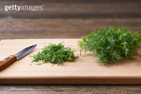 Fresh Chopped Green Dill Leaves On A Cutting Board Selective Focus