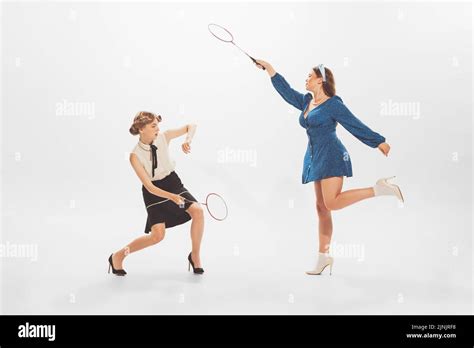 Portrait Of Young Beautiful Stylish Women Playing Badminton Posing