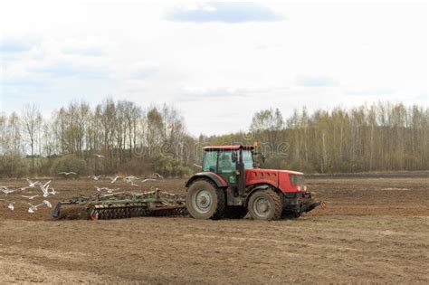 The Tractor Plows The Field In The Spring Editorial Photo Image Of