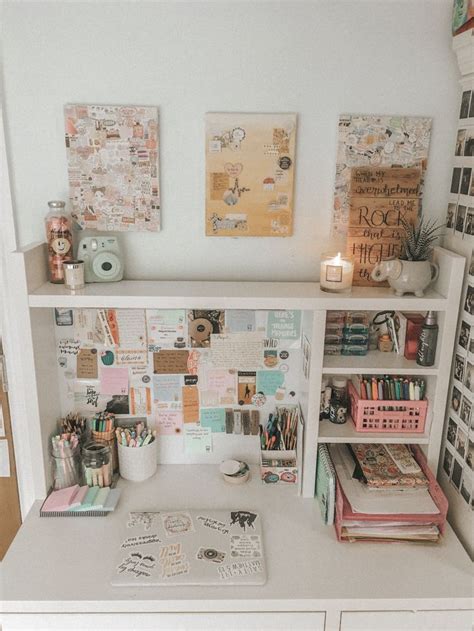 A White Desk Topped With Lots Of Clutter And Books Next To A Wall