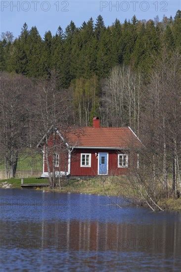 Swedish Red Wooden Cabin Along River In Spring Photo Imagebroker