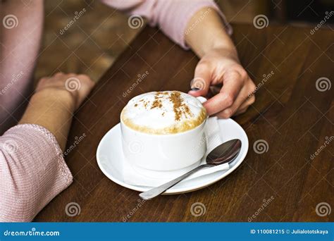 Female Hands Hold A Cup Of Cappuccino In A Cafe Stock Image Image Of