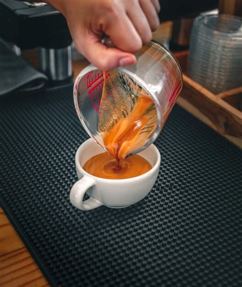 Premium Photo Closeup Shot Of Barista Hand Pouring Espresso In