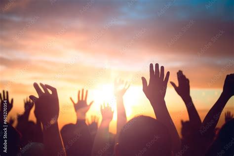 Worship and praise concept: christian people hand rising on sunset ...