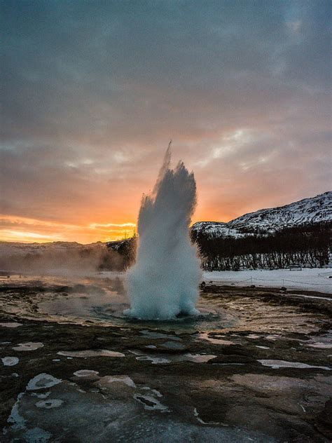 Strokkur winter blowup in front of sunset Photograph by Benjamin ...