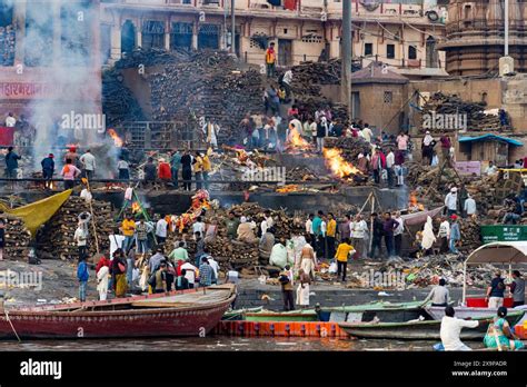 People Gather For A Ritual Funeral Pyre Cremation Along The Sacred