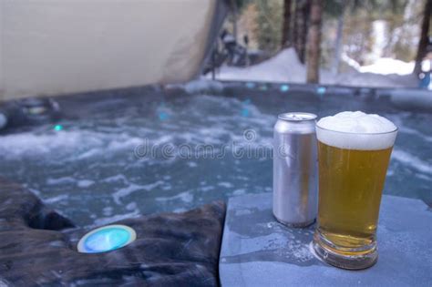 Glass Of Cold Beer And Outdoor Hot Tub Jacuzzi Winter Scene Relaxing Resort Stock Photo