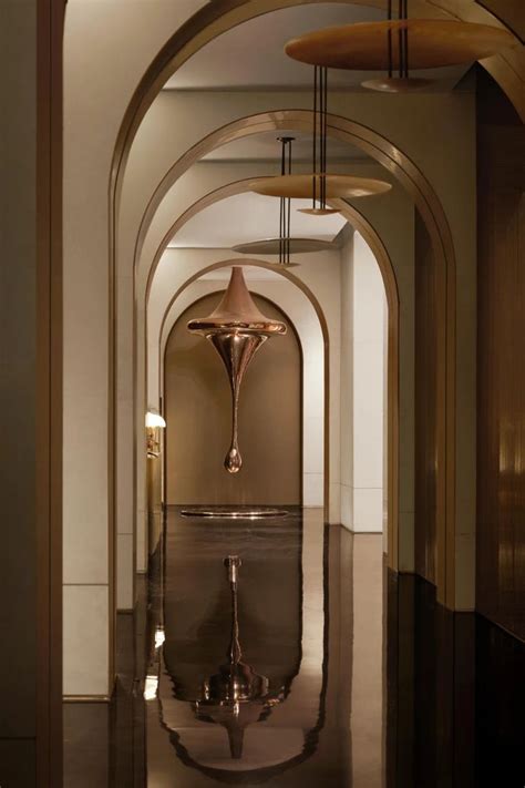 An Archway Leading Into A Hallway With Lights On The Ceiling And Water