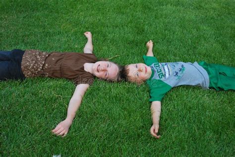 Kids Laying On Grass Royalty Free Stock Photos - Image: 5954918