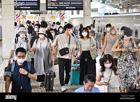 Families And Other Passengers Gather At A Platform Of Shinkansen Bullet