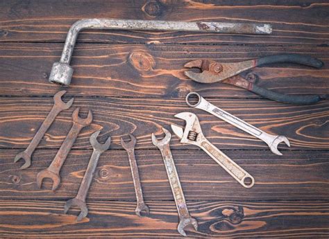 There Are Many Wrenches On The Table And One Is Open To Show It S Contents