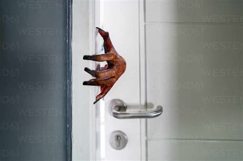 Close Up Of Zombie Hand At Door Stock Photo