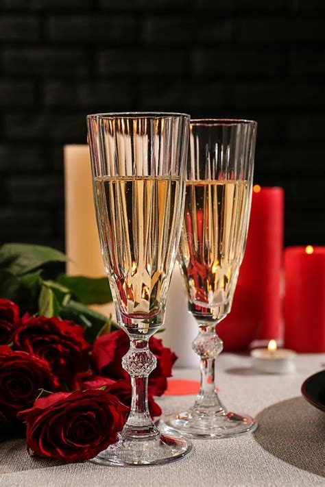 Glasses Of Champagne With Red Roses On Festive Table Valentines Day