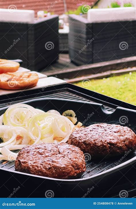 Cooking Minced Beef Burger on Cast Iron Grill Skillet Outdoors, Red Meat on Frying Pan, Grilling ...