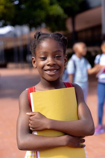 Premium Photo Portrait Of Happy African American Schoolgirl Standing