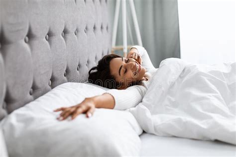 Satisfied Young African American Woman Stretching After Wake Up Stock