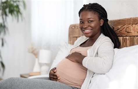 Enjoying Pregnancy Cheerful Black Pregnant Woman Resting In Bed