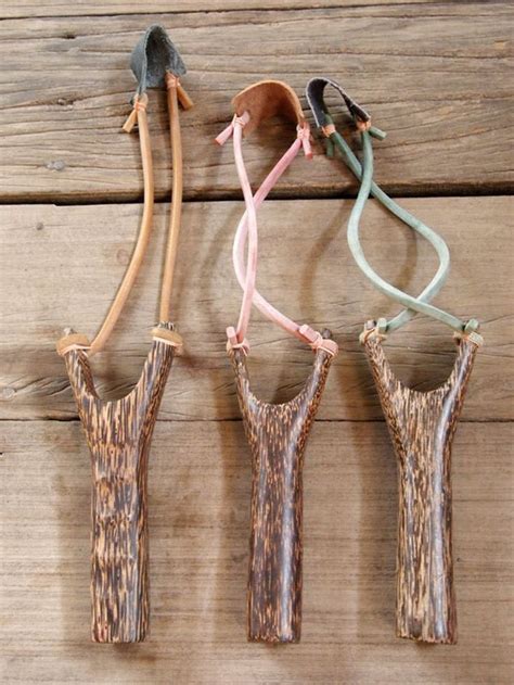 Four Pieces Of Wood With Different Colored Cords Attached To Them