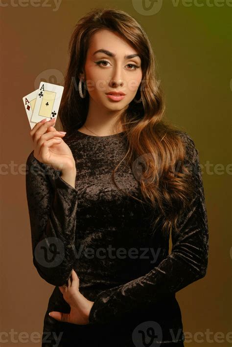 Brunette Woman In Black Velvet Dress And Jewelry Showing Two Aces