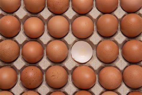 Premium Photo Top View Of A Broken Egg Around By Many Eggs On Carton